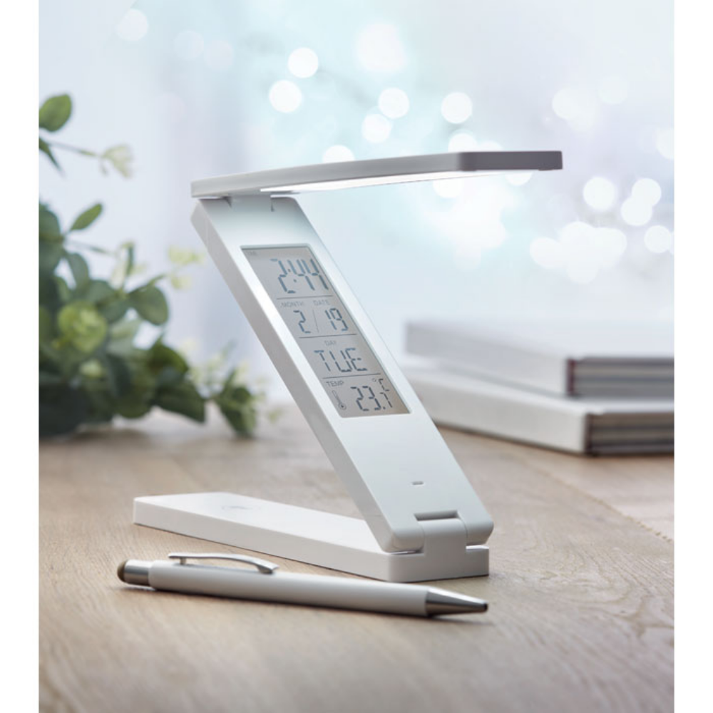 A foldable LED desk lamp that is also equipped with a weather station. It's manufactured by Little Hayfield. - Appleton Thorn