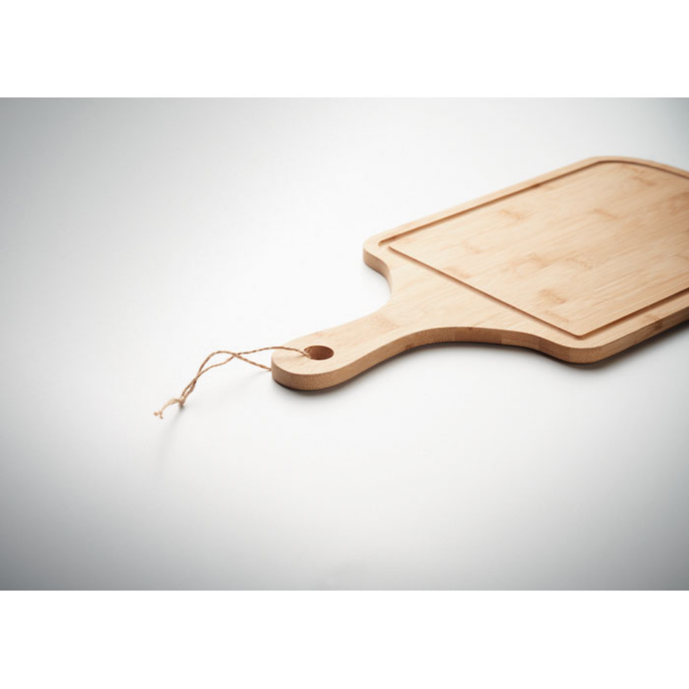 A Woolpit serving board made from bamboo, includes a groove detail and a jute rope handle. - Great Bowden