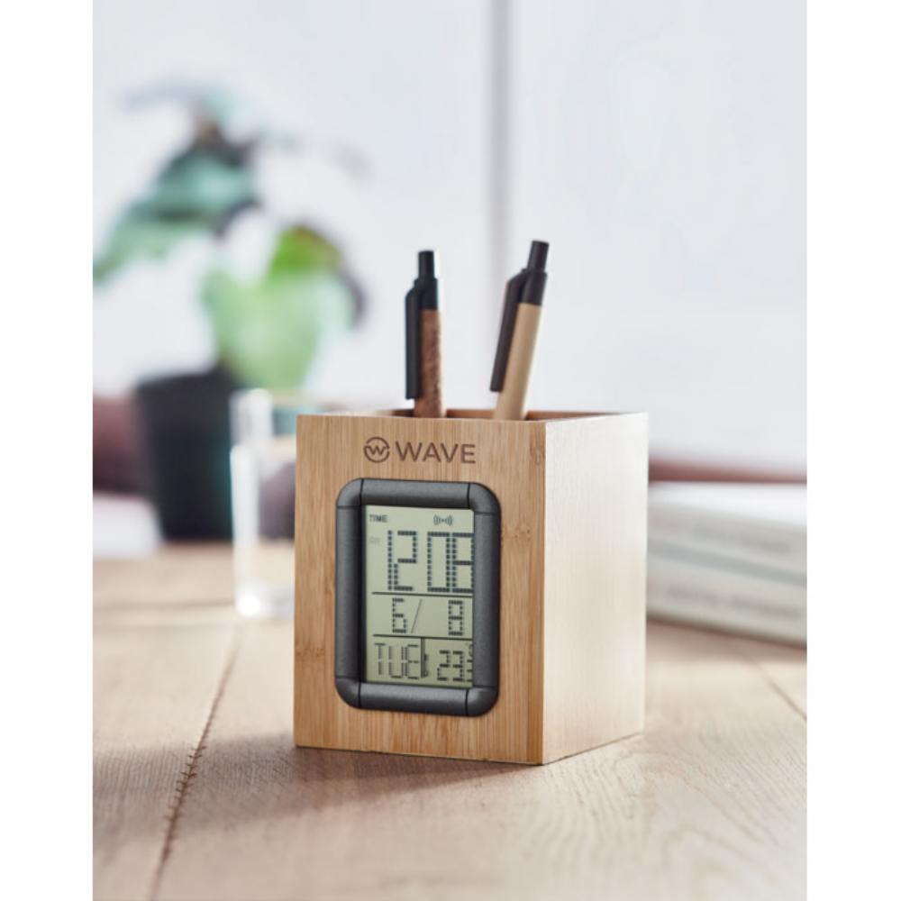 A Bishop Burton bamboo pen holder that also features a calendar, alarm clock, and thermometer. - Huntly