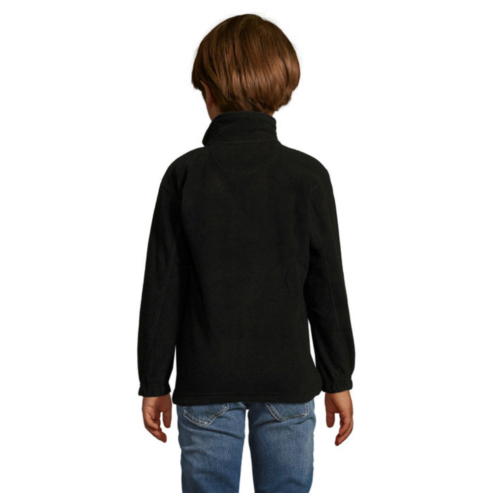 A children's fleece sweater featuring anti-pilling, a banded neck seam, a high lined collar, two zipped pockets, and a front zipper. It also includes elasticated cuffs, an extended back panel, and an inner drawstring hem - Little Walsingham - Achnashellach