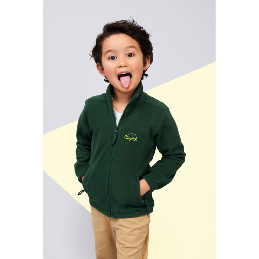 A children's fleece sweater featuring anti-pilling, a banded neck seam, a high lined collar, two zipped pockets, and a front zipper. It also includes elasticated cuffs, an extended back panel, and an inner drawstring hem - Little Walsingham - Achnashellach